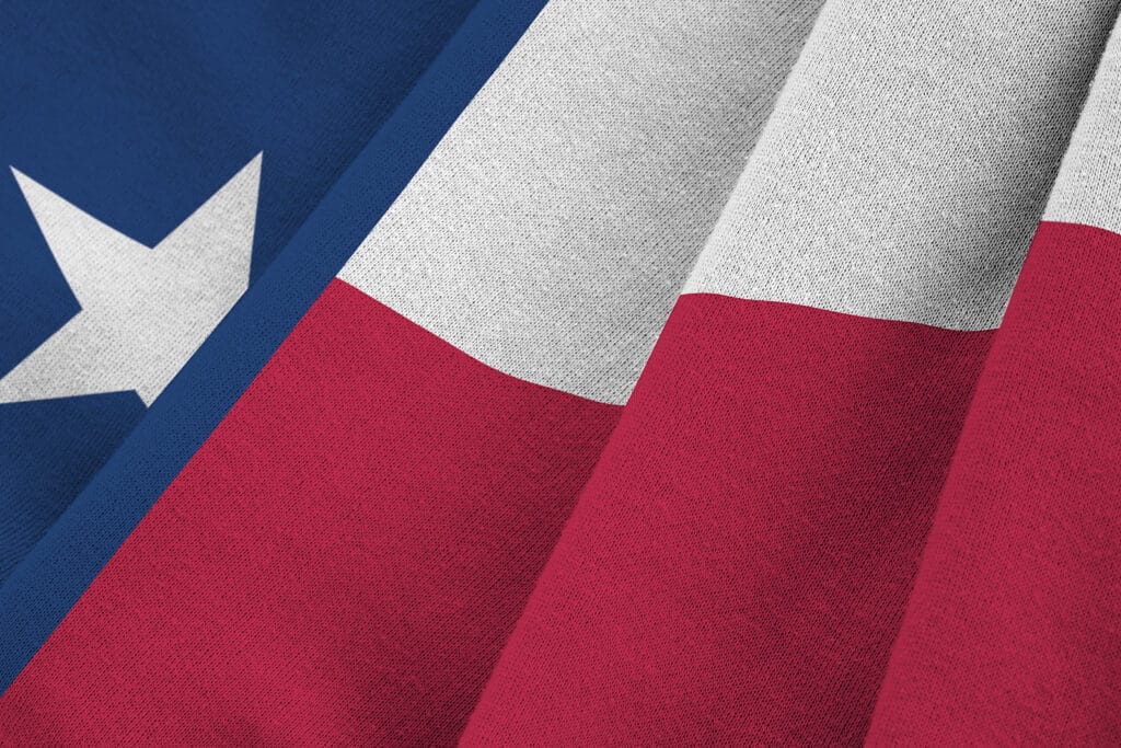 Texas Us State Flag With Big Folds Waving Close Up Under The Stu